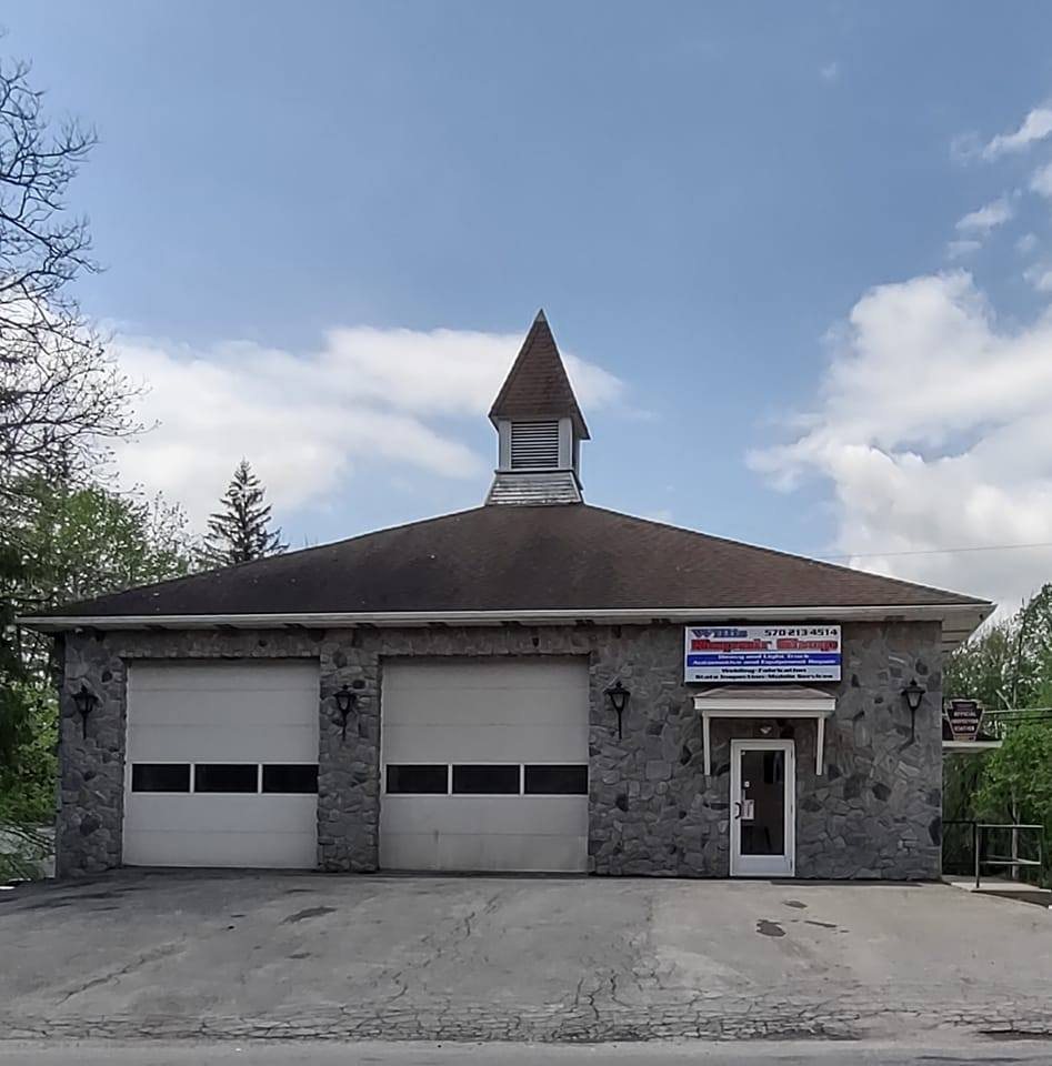 Willis Repair Shop building at 105 Marshalls Creek Rd with two bay doors and the shop sign